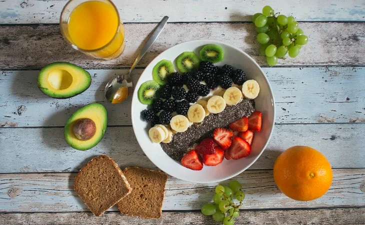 Vegan kahvaltı tabağı: chia tohumu, muz, kivi, böğürtlen, çilek, avokado, tam buğday ekmeği ve taze meyve suyu