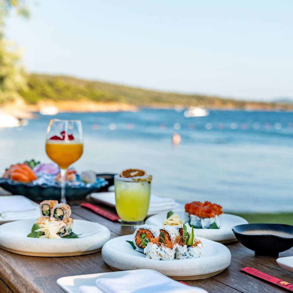 Cunda'nın mavi Ege sularına nazır bir masada, özenle hazırlanmış suşi ve saşimi çeşitleri ile ferahlatıcı kokteyller, adanın dingin atmosferinde unutulmaz bir gastronomik deneyim sunuyor.