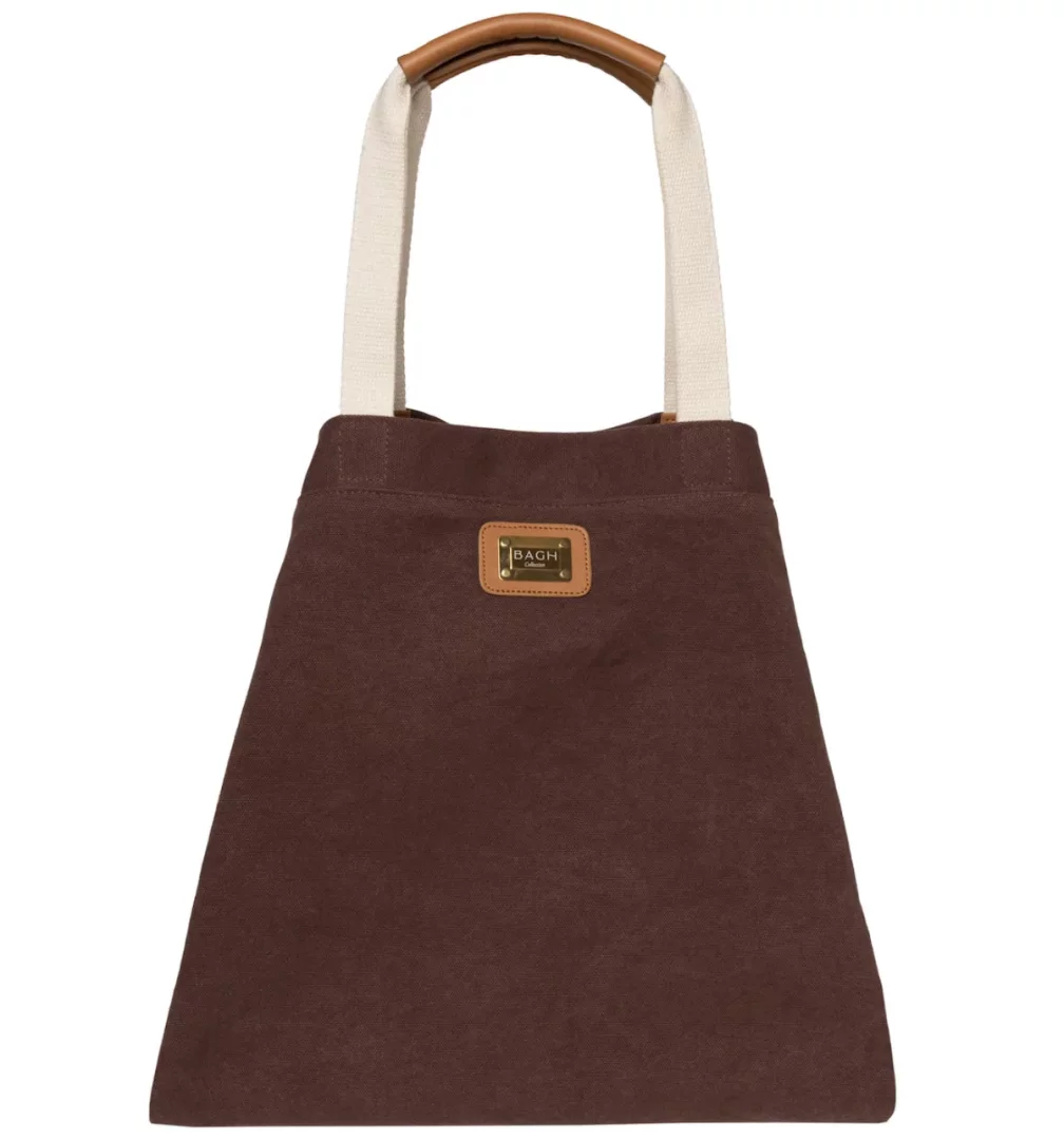 Kestane rengi kumaştan yapılmış, üst kısmında BAGH Collection markasının logosu bulunan, krem rengi askılı ve kahverengi deri sap detaylı, modern ve kullanışlı bir tote çanta beyaz zeminde sergilenmektedir.