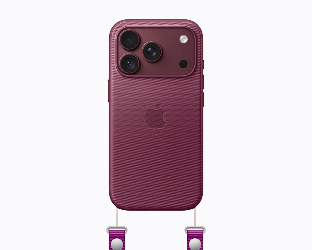 Koyu bordo renginde, ince dokulu yüzeye sahip bir iPhone'un arka görünümü; sol üst köşesinde üçlü kamera sistemi ve flaş, ortasında kabartma Apple logosu ve alt köşelerinden sarkan iki mor renkli kordon tutacağı detaylarıyla bu cihazın modern tasarımını ve taşınabilirlik özelliklerini vurguluyor.