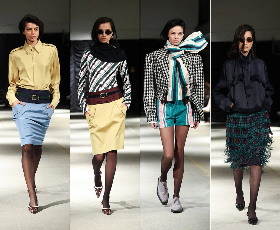Londra Moda Haftası'nda Mithridate'in koleksiyonundan bir sahne; dört model, podyumda soldan sağa doğru sarı gömlekli ve mavi etekli, çizgili bluzlu ve sarı etekli, ekoseli blazer ve çizgili şortlu, son olarak lacivert ceket ve püsküllü ekose etekli cesur tasarımları sergiliyor.